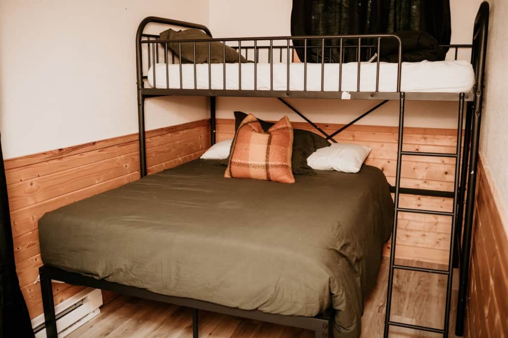 Bedroom with twin bunk bed over a full 