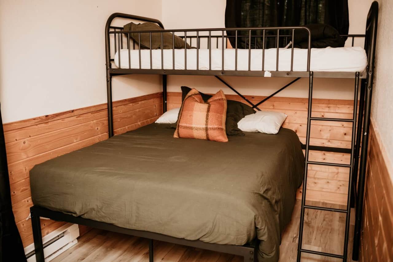 Bedroom with twin bunk bed over a full 
