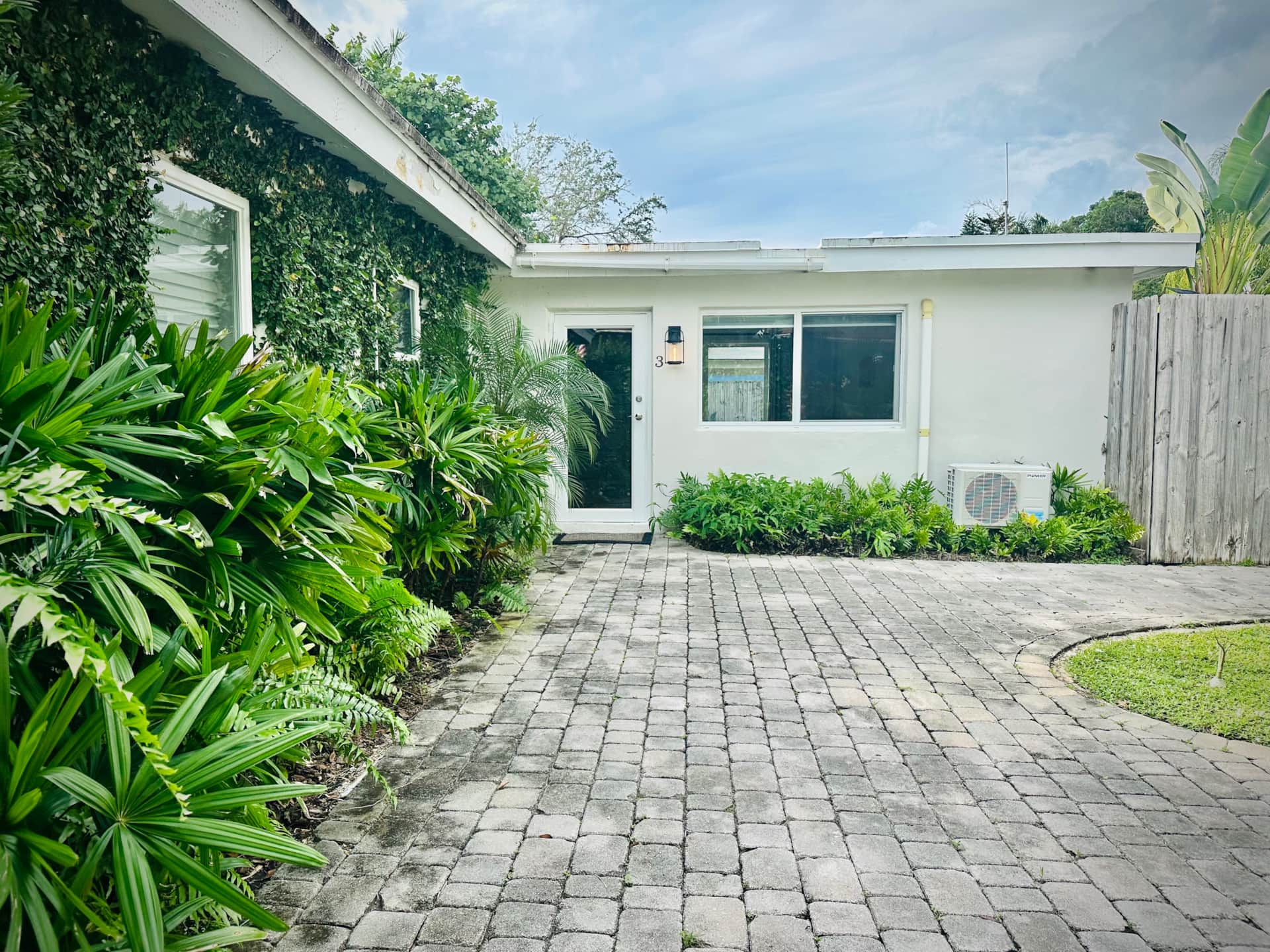 After renovation courtyard at Casa Citron featuring newly planted landscaping and refined outdoor paths