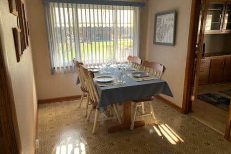 Kitchen table with seating for four and a bar that seats two.