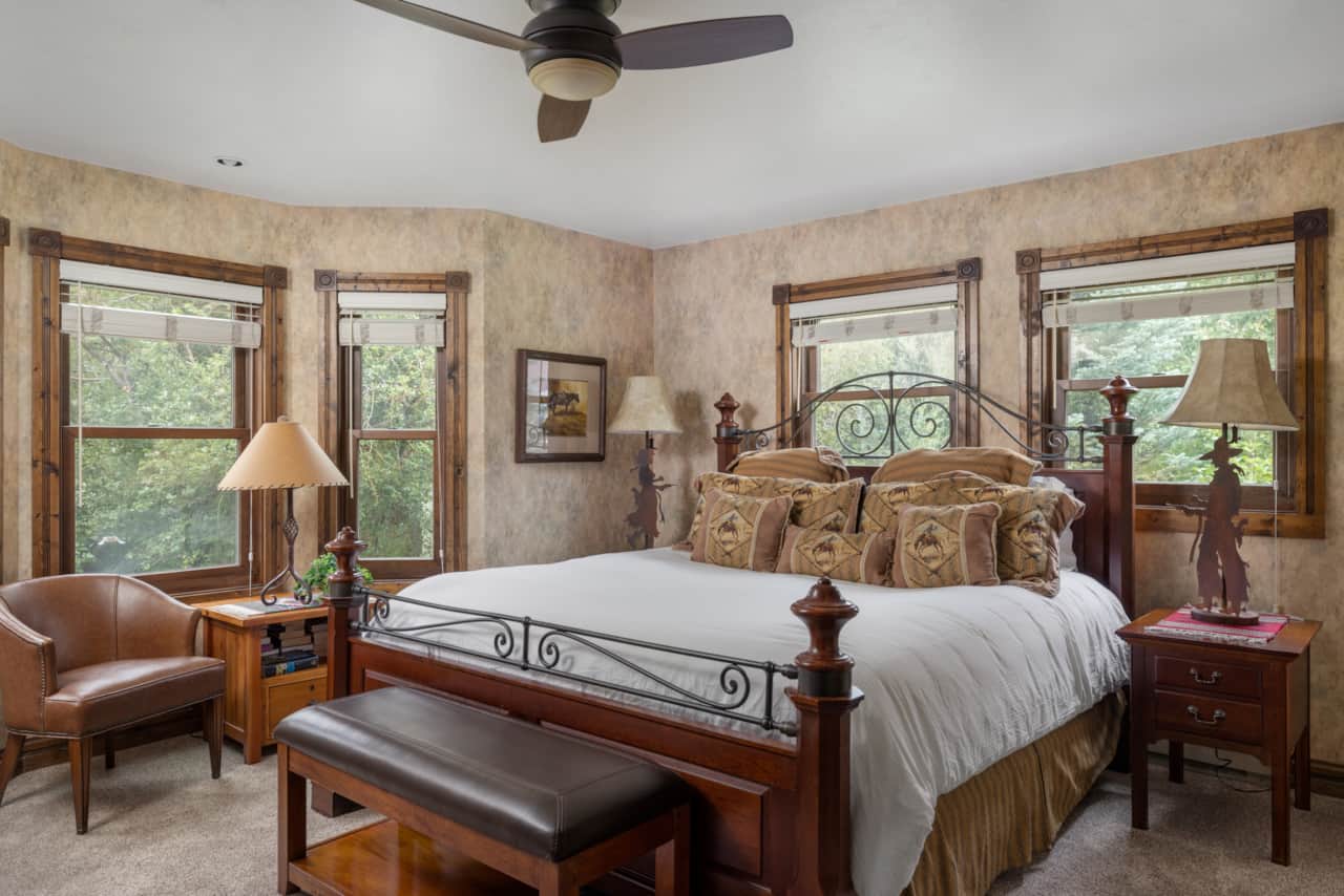 Spacious primary bedroom with king bed and flat screen TV