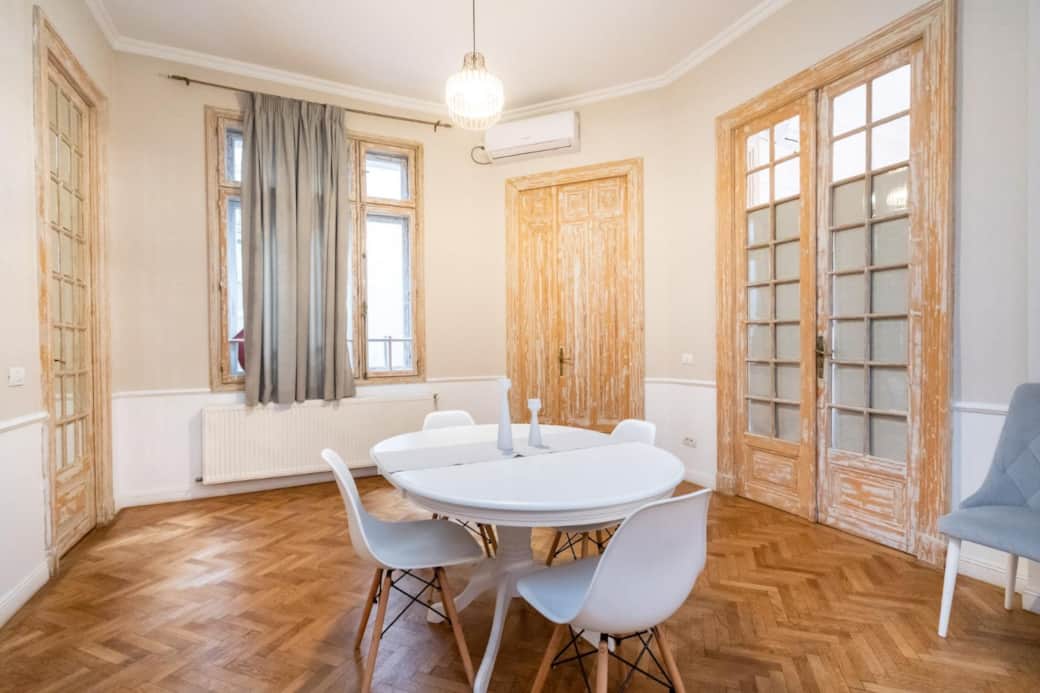 Dining area with large table in Central Bucharest apartment Dining area with large table in Central Bucharest apartment