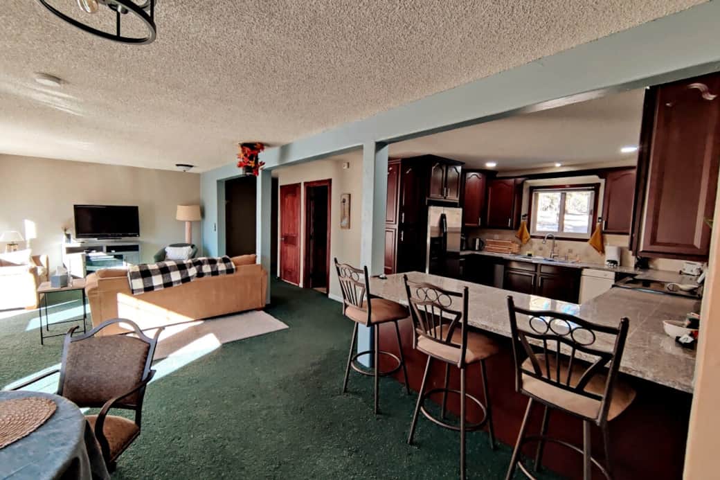 The bar island seating at the kitchen and round breakfast nook table provide additional seating for meals and conversation
