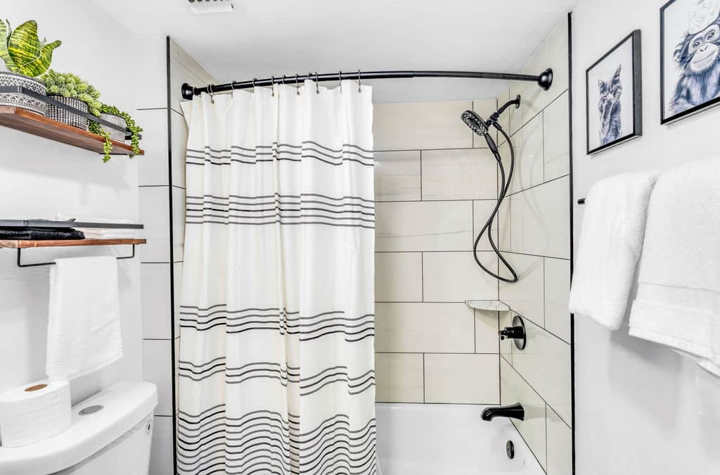 Kid-friendly full bath with soaking tub + fun black & white animal theme—splash time approved!