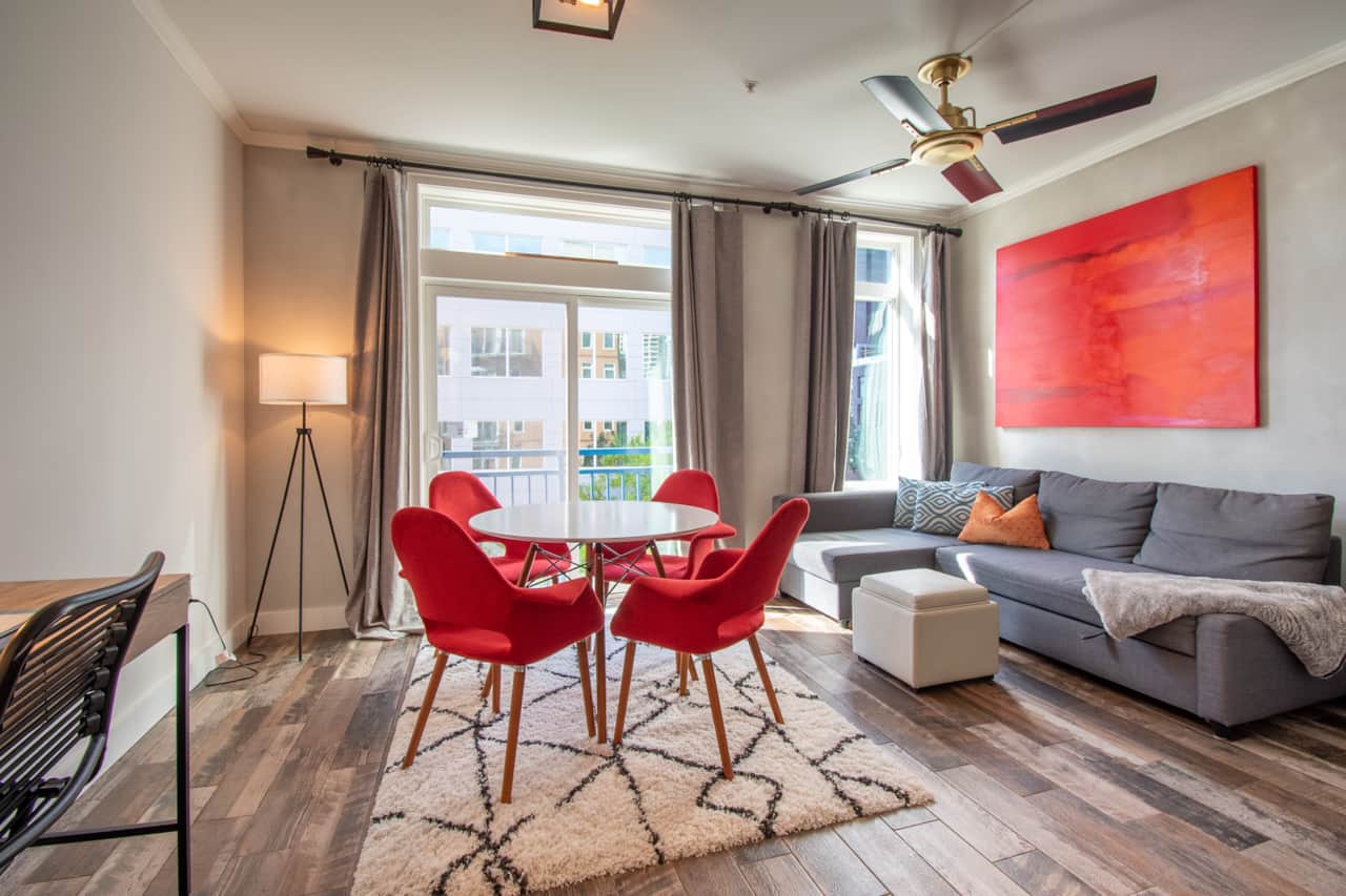 Spacious living room with comfortable dining chairs, a work desk and comfortable sofa bed