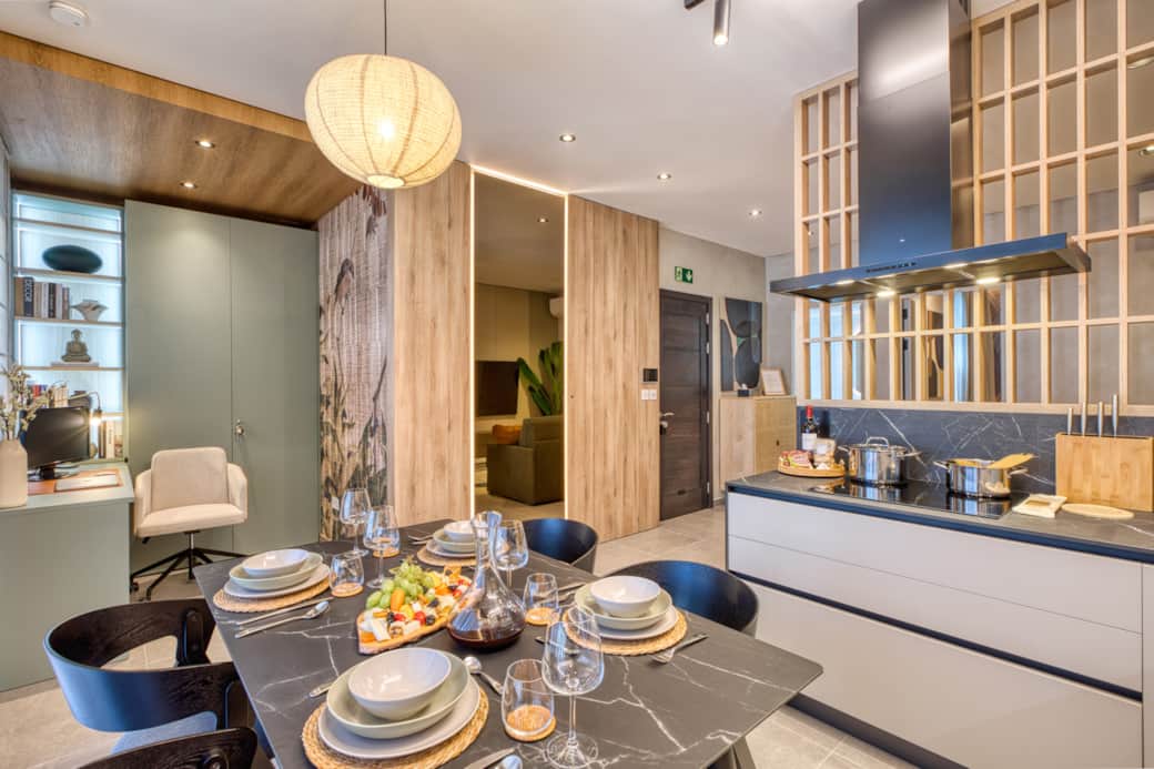 A glimpse of the kitchen, dining, and workspace areas blending together in an open-plan design. A glimpse of the kitchen, dining, and workspace areas blending together in an open-plan design.