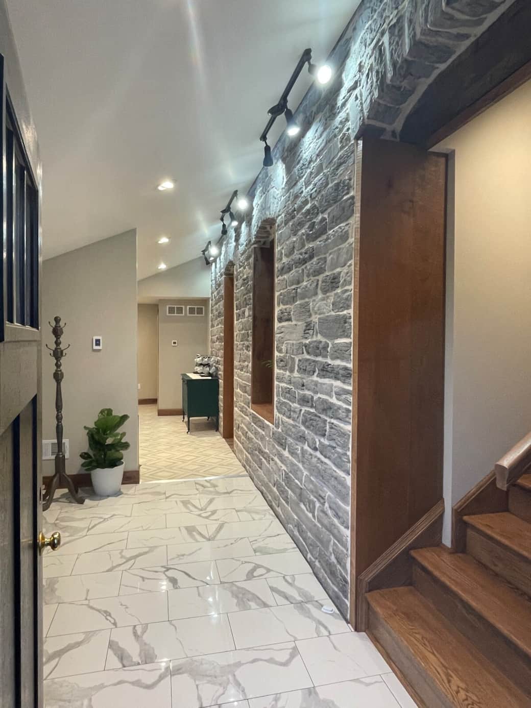 Looking into the entryway from the front door. The stairs to bedroom 2 and bedroom 3 are to the right. 