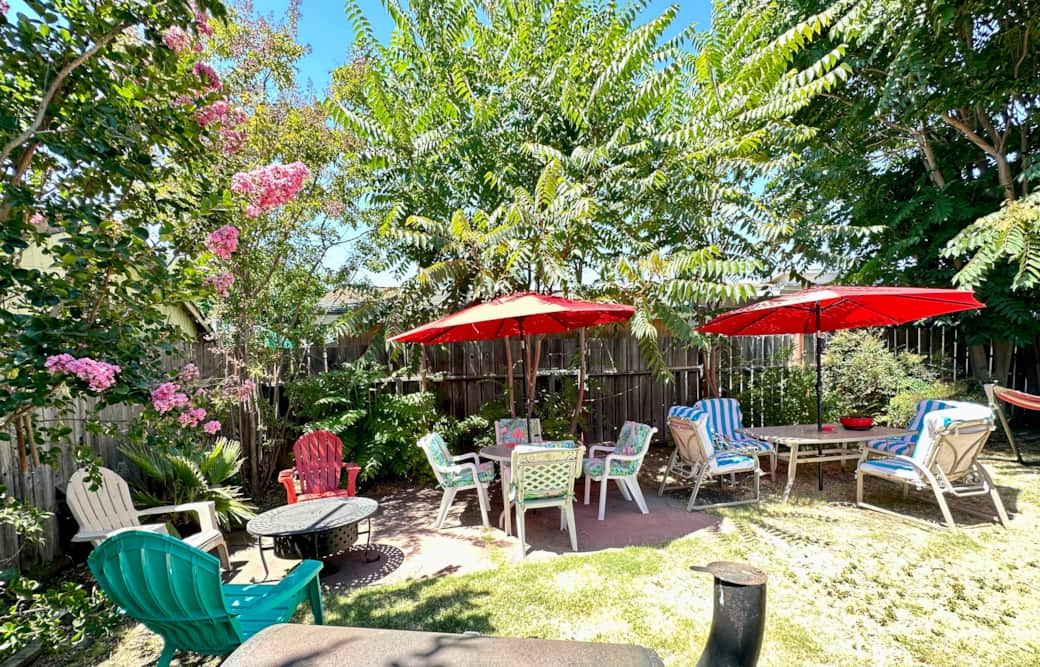 Private-backyard-patio-outdoor-seating-barbecue pit-umbrellas-garden-lounge-area