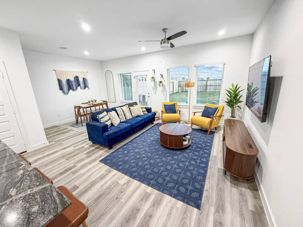 Bright, open living room with stylish furnishings, plush seating, and modern décor. Enjoy natural light, a large smart TV, and a cozy layout perfect for relaxing after a day in the city.