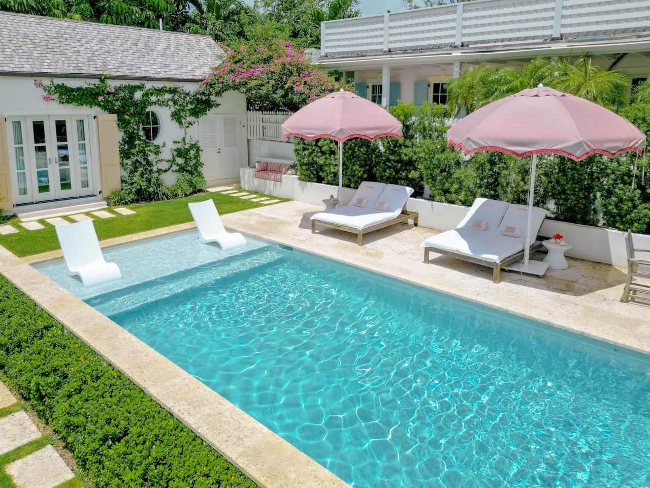 Dunmore Cottage Harbour Island pool with sun shelf loungers, patio seating, and adjacent cottage