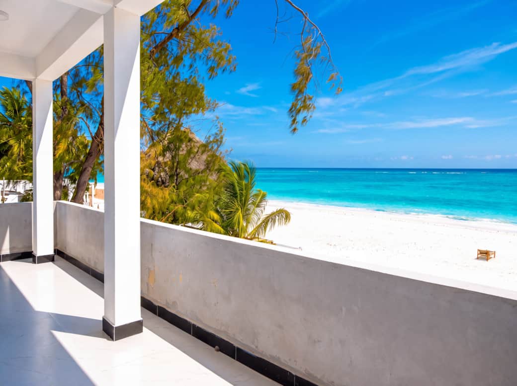 Wake up to your private balcony facing the Indian Ocean — white sand and turquoise water await. (9