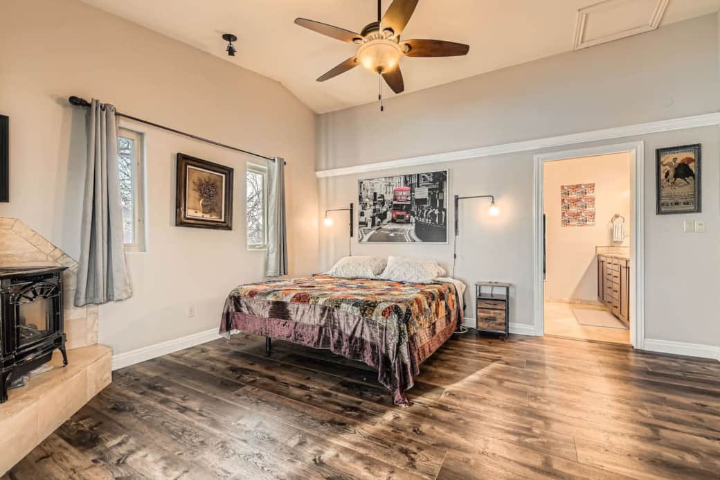 The suite's primary sleeping area is spacious and filled with natural light. The gas fireplace. The suite's primary sleeping area is spacious and filled with natural light. The gas fireplace.