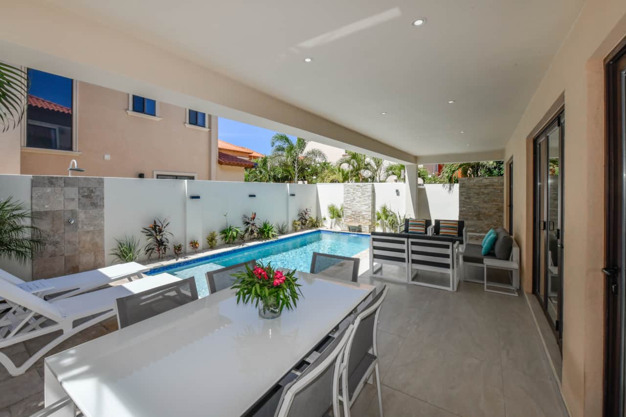 Pagoda-covered dining table and conversation set, private pool, sun loungers, and outdoor shower