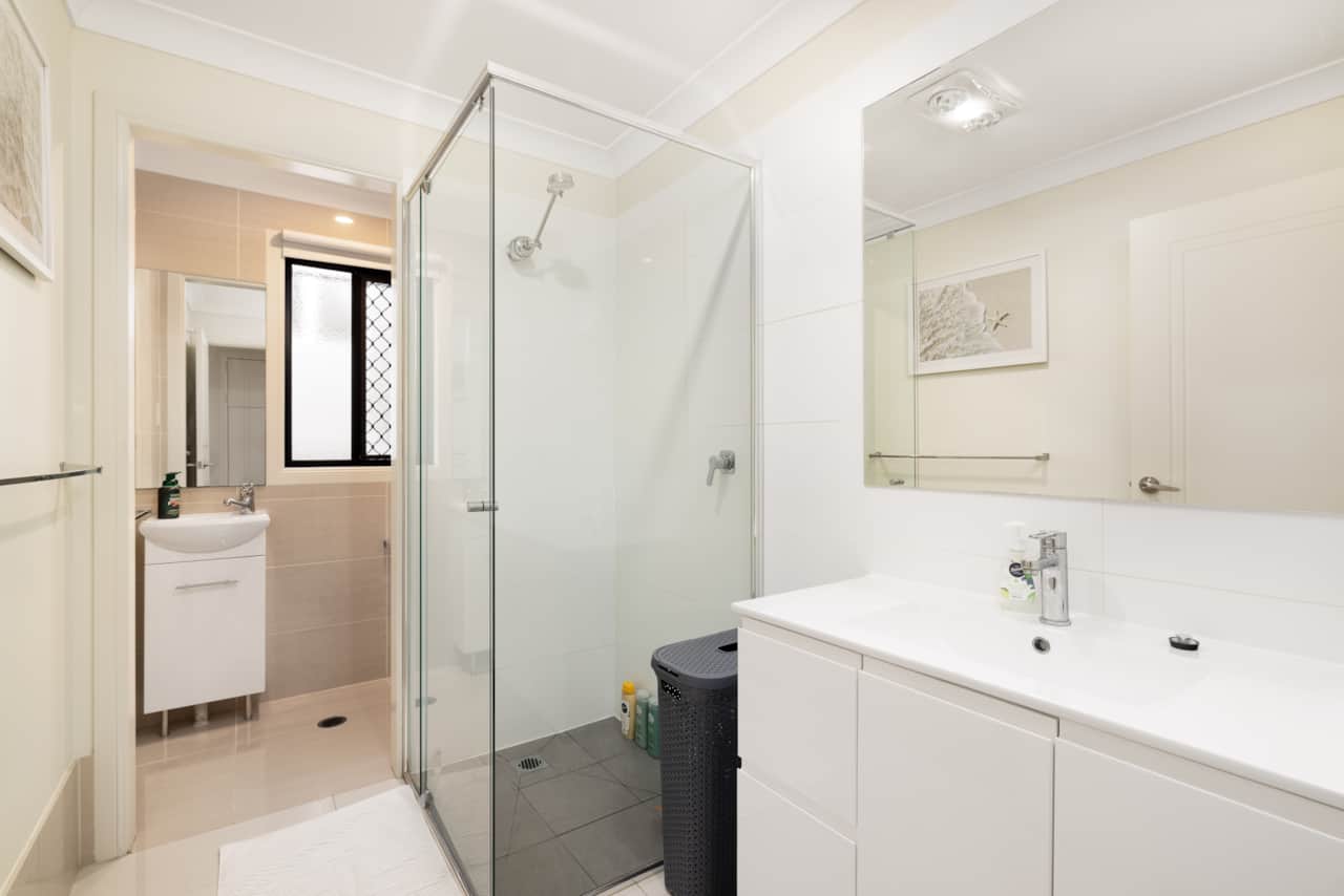 Bathroom: Stylish bathroom with walk-in shower, vanity, and clean finishes