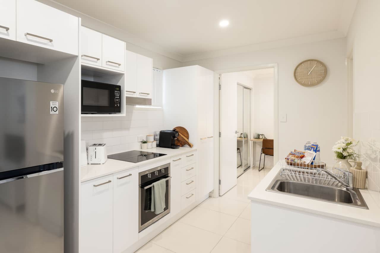 Kitchen: Sleek kitchen with ample storage, modern appliances 