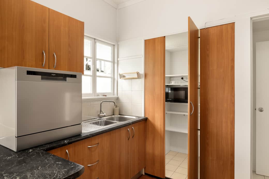 Kitchen: Sleek kitchen with ample storage, modern appliances Kitchen: Sleek kitchen with ample storage, modern appliances