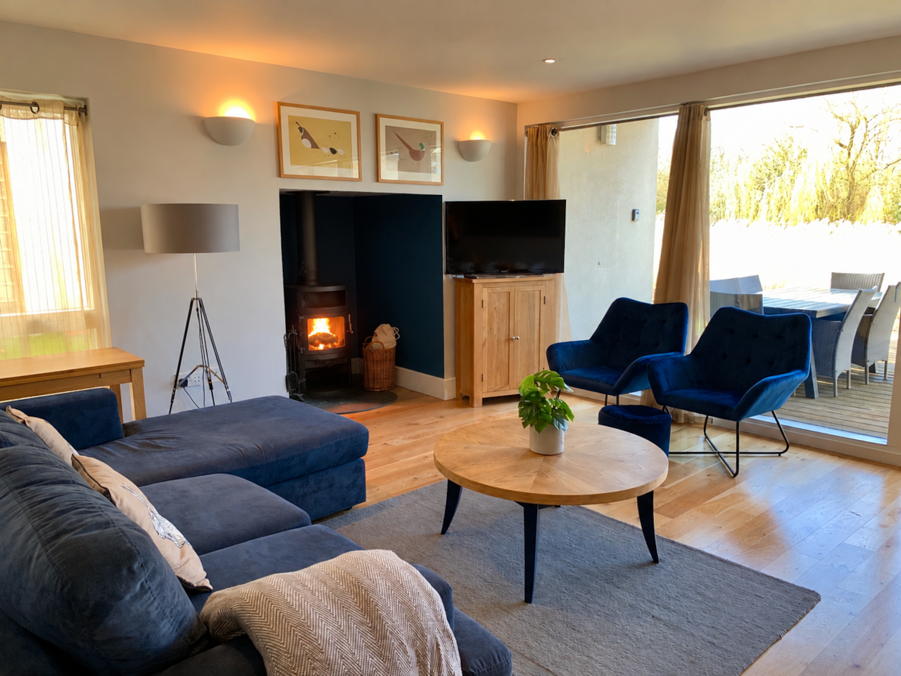 Get cosy in the open plan living space, with wood burner and lake view