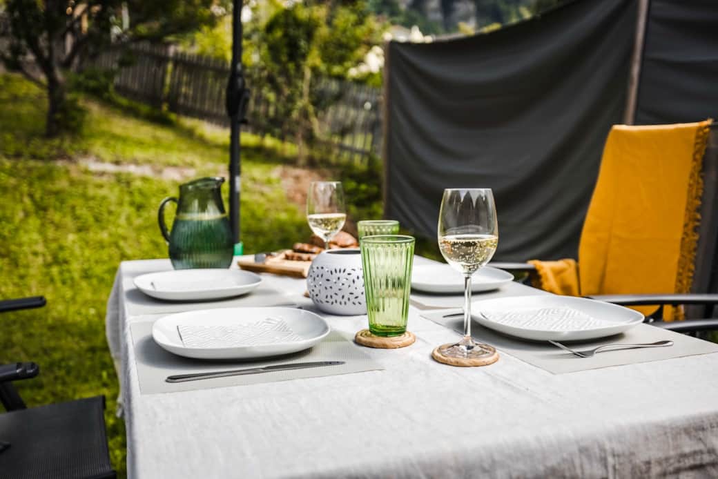 Outdoor dining table in Chalet Oz garden set for a summer meal Outdoor dining table in Chalet Oz garden set for a summer meal