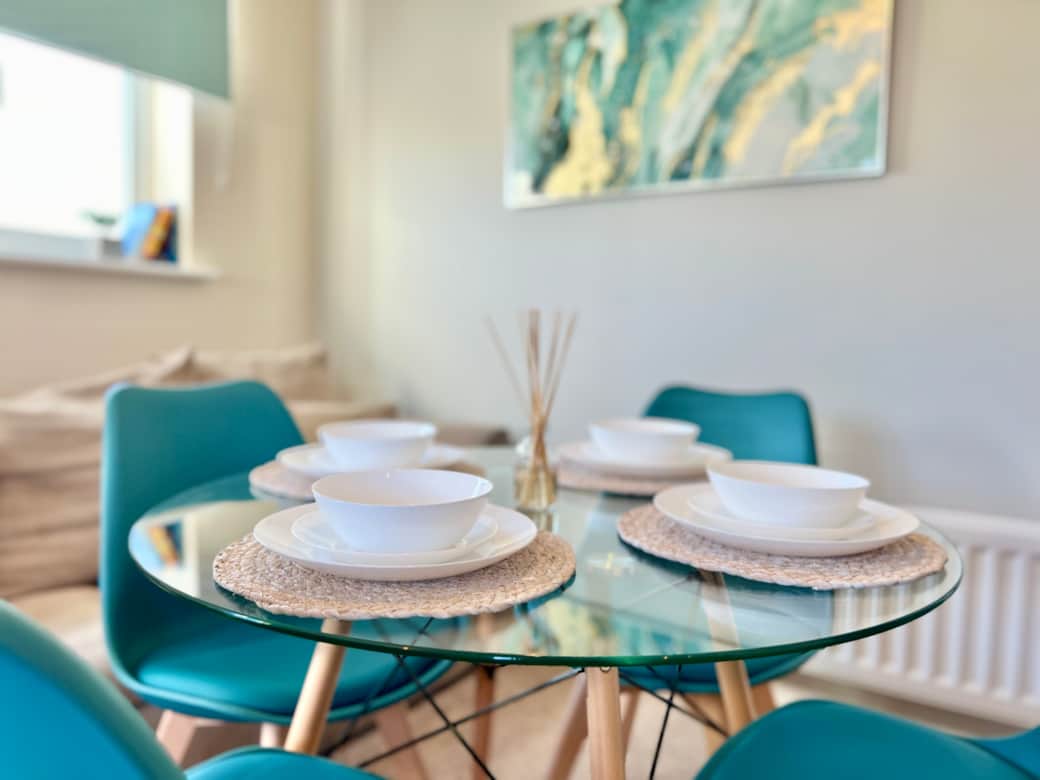 Dining table - Colourful chairs and a table that sits four for meals.