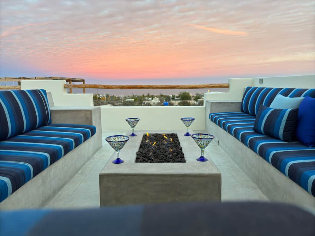 Snuggle up on the rooftop with comfy seating, breathtaking views, and a fire table for cooler nights