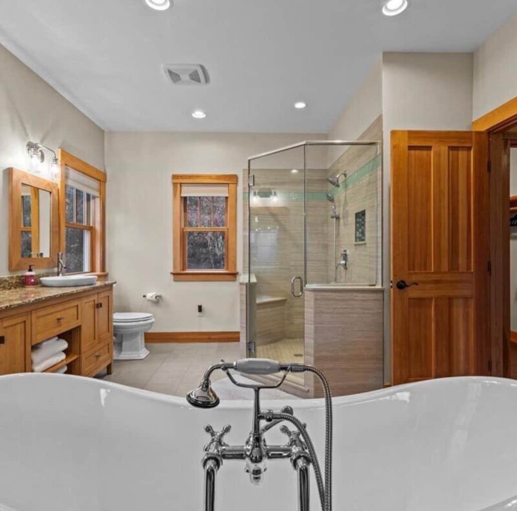 Spacious full bathroom featuring a glass walk-in shower, double vanity, and a relaxing soaking tub for a spa-like experience.