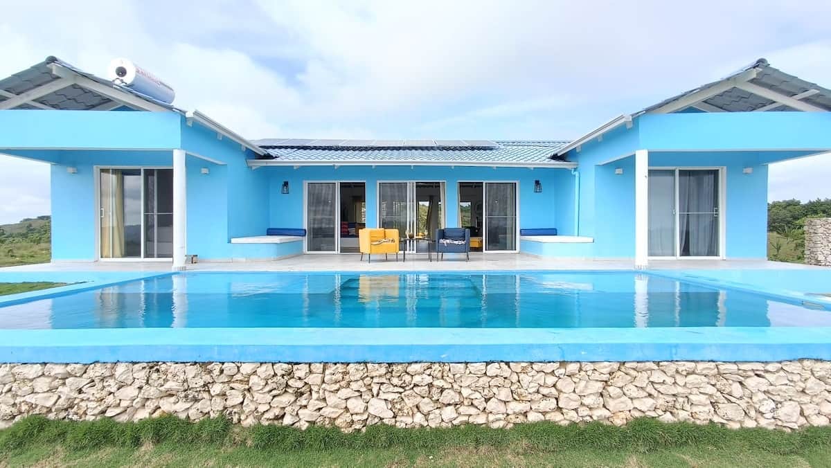The Blue House with its pool and tropical hillside surroundings