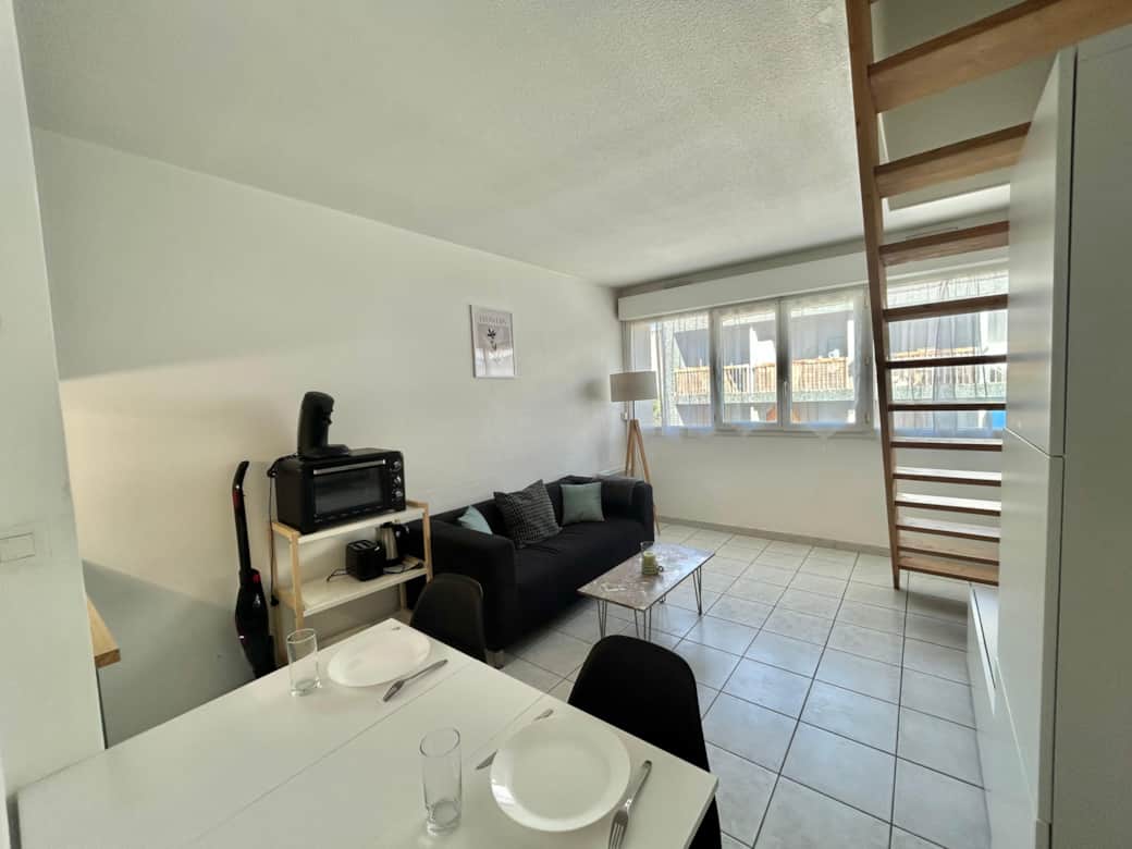 Living room, sofa, dining table, chairs, lamp, coffee table, kitchen, micro wave, TV, stairs