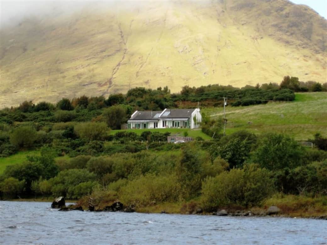 Charming lakefront cottage surrounded by rolling green hills and mountain air.