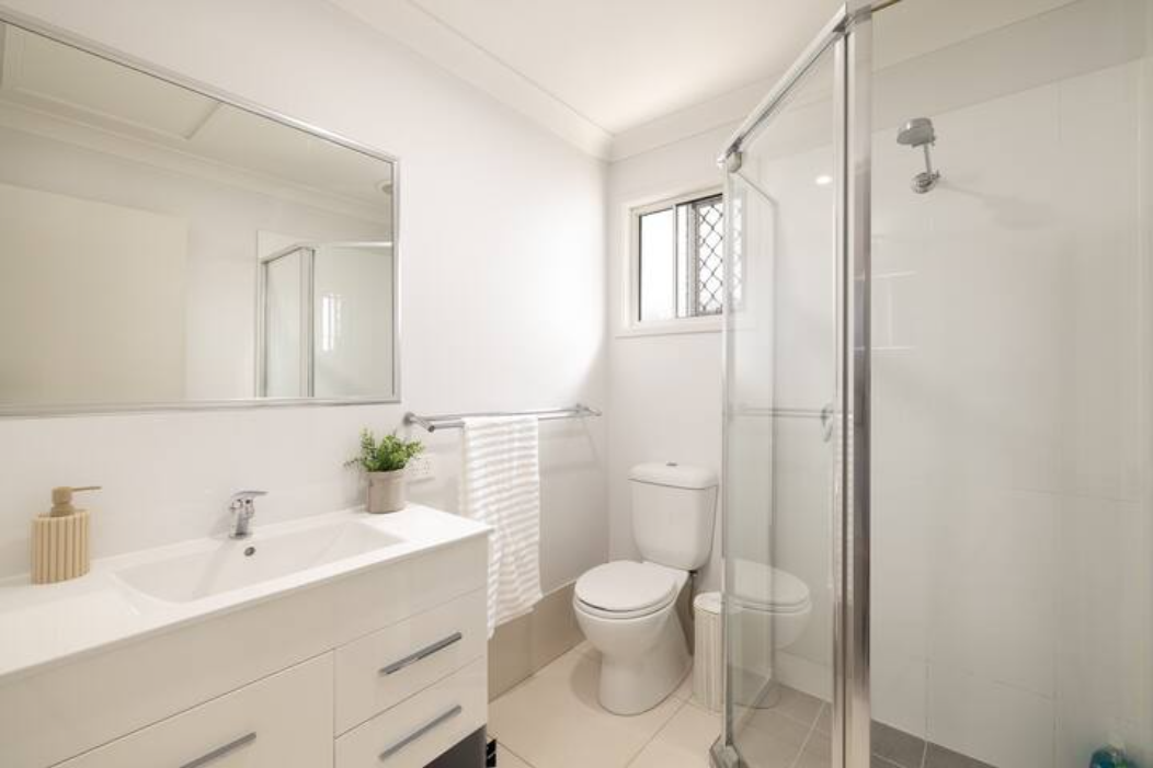 Bathroom: Stylish bathroom with walk-in shower, vanity, and clean finishes 