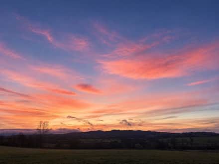 Spring sunset over the countryside at The Cotswold Barn