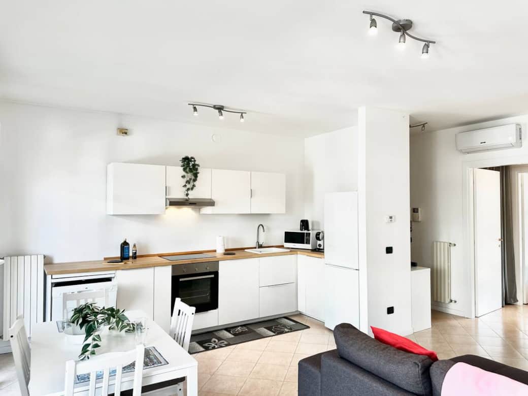 The open-plan kitchen is fully equipped with an oven, dishwasher, toaster, kettle, and coffee machine, making it perfect for socialising.