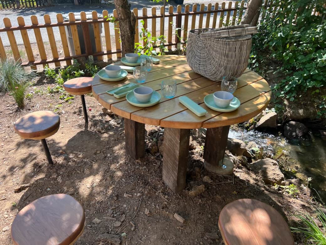 Enjoy an outdoor meal under the trees with a provided picnic basket and tableware. A peaceful spot for morning coffee, lunch in the sun, or a shared evening meal.