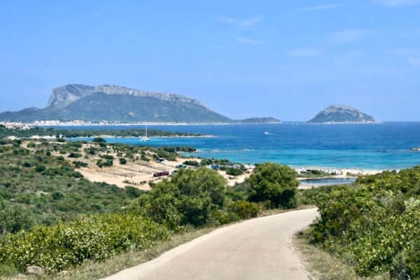 Crystal-clear shallow water at Pittulongu — safe gradual entry ideal for families with children, north-east Sardinia