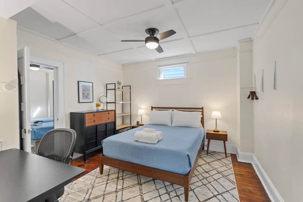 Bedroom #3 w/adjoining door to bedroom #2 open. Mid century modern highboy dresser,  large shelf, two bedside tables and lamps w/power outlets. Clothes hangers on the wall to store all your belongings during your stay. Sound machine in each bedroom.