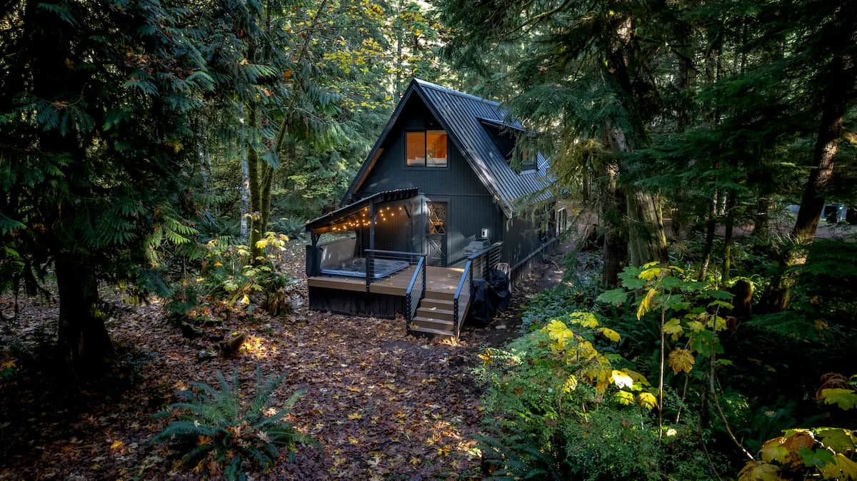 Alpine Abode spans nearly an acre across two lots. Immerse yourself in the tranquility of the natural surroundings, complete with towering trees, lush ferns, and perhaps even a visit from a deer or two.