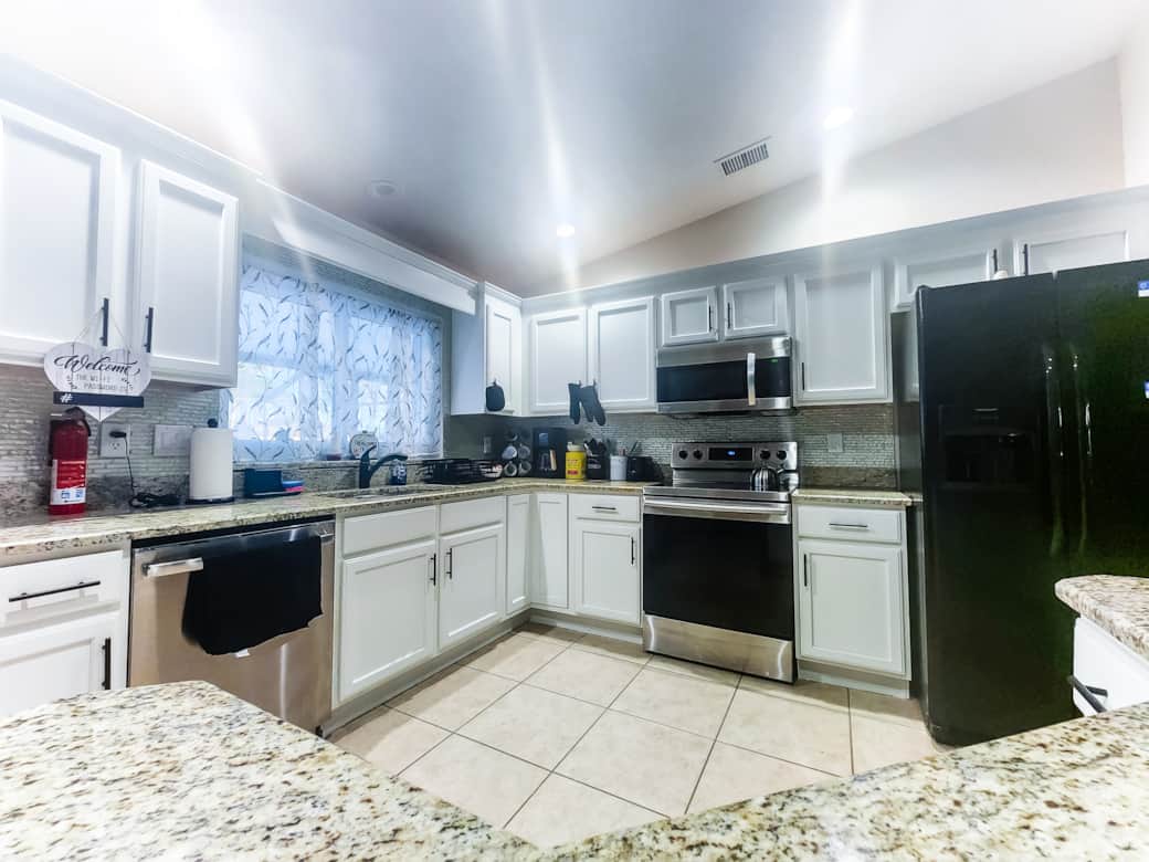 Fully stocked Kitchen with appliances and island with stools Fully stocked Kitchen with appliances and island with stools