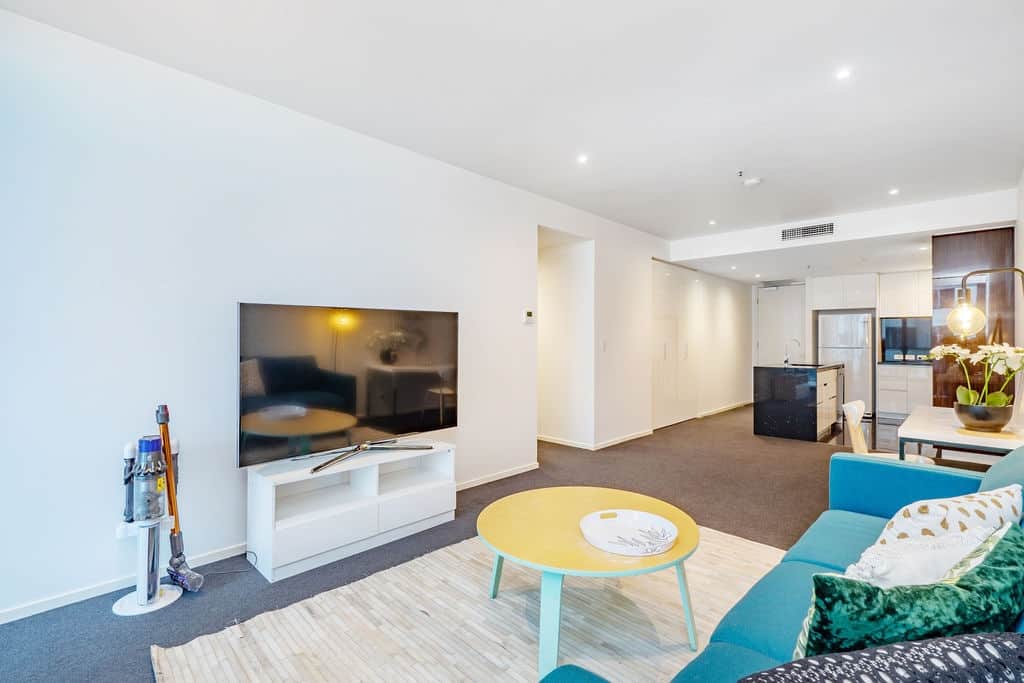 Entertain and relax in our open-concept living area. The flat-screen TV and comfortable seating provide an ideal setting for movie nights or catching up with friends. The bright, airy space is designed to make you feel right at home