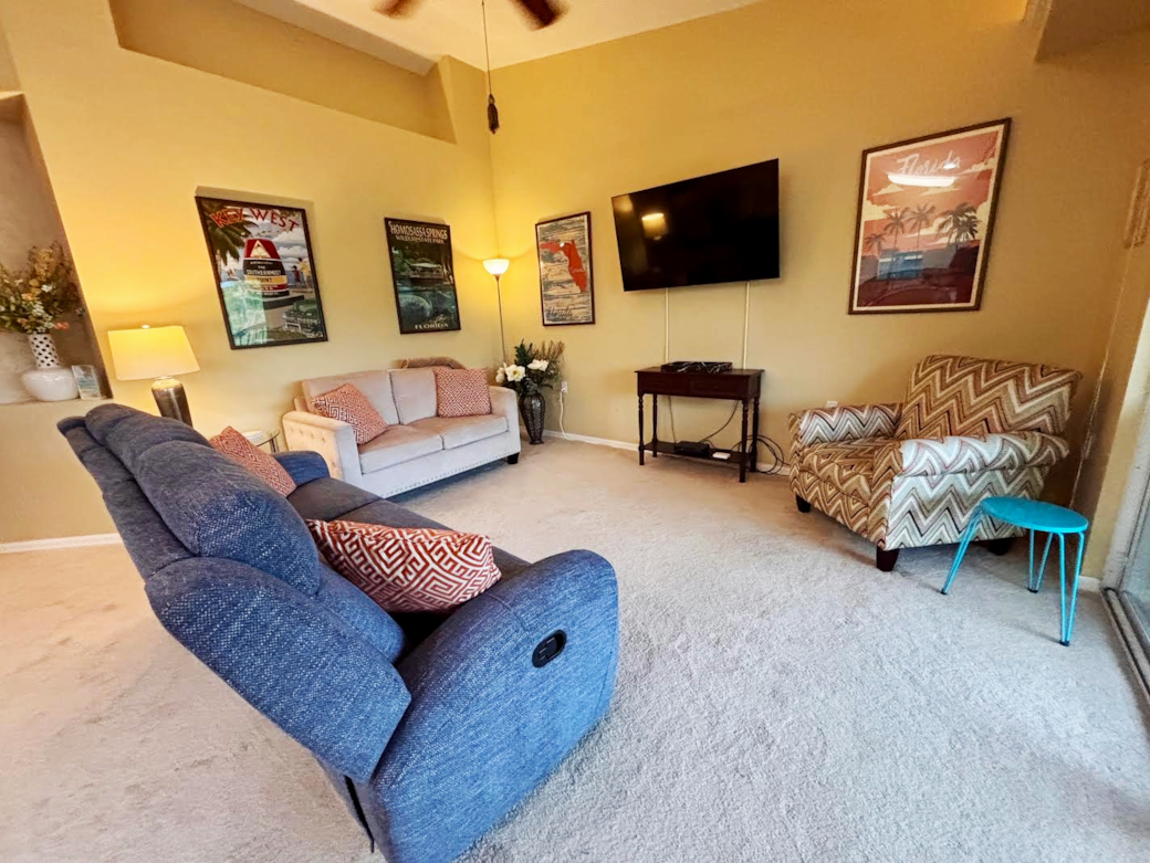 Living Room with two sofas, a chair, and a 55" HD TV