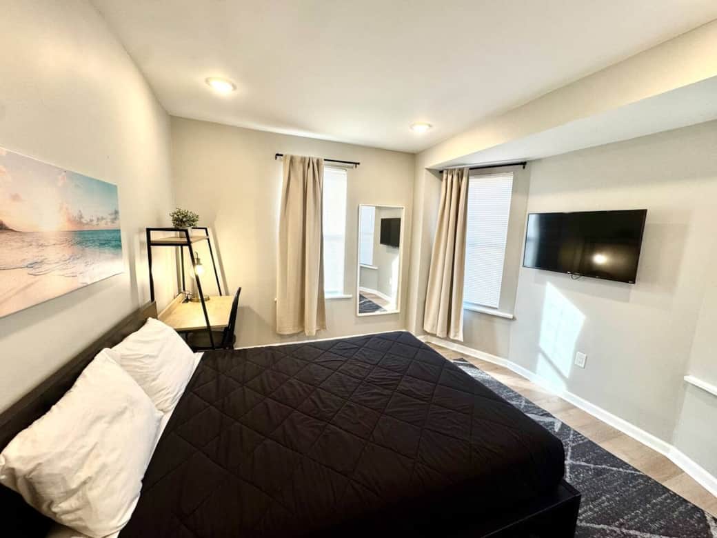 
Relax in our well-appointed bedroom, featuring a comfortable queen-sized bed and a convenient nightstand. Enjoy ample storage space with a large closet.
For entertainment, a flat-screen TV is provided, ensuring a pleasant restful stay, and a desk.