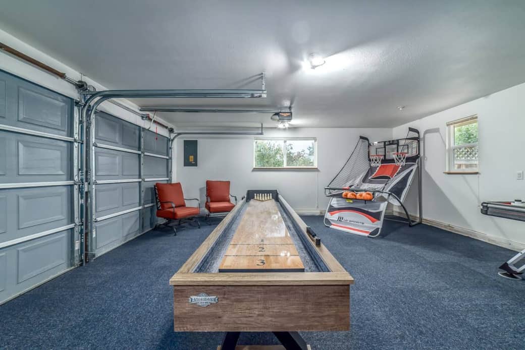 Game room with Shuffleboard table and basketball game. Game room with Shuffleboard table and basketball game.