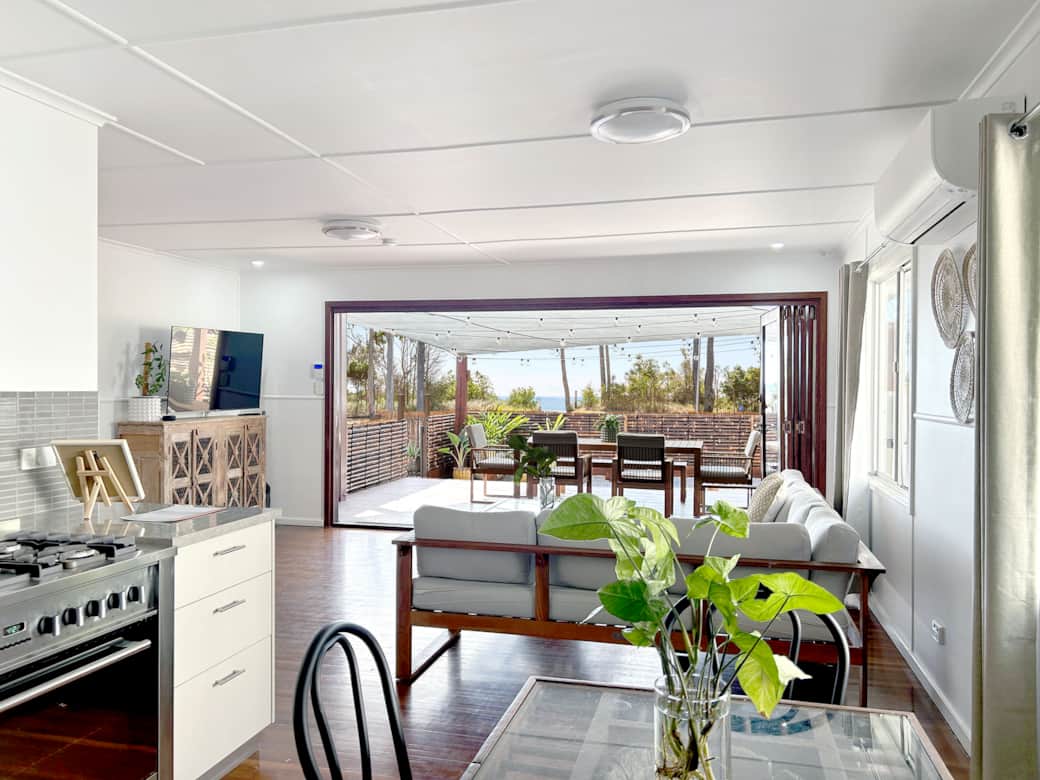 Internal photo of kitchen, lounge and outlook to front deck with ocean views