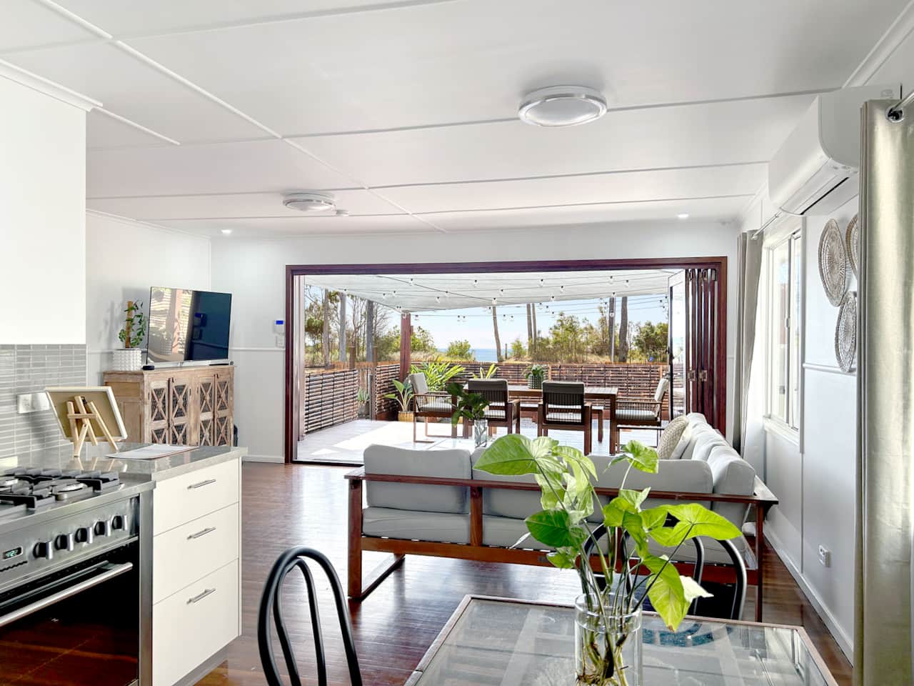 Internal photo of kitchen, lounge and outlook to front deck with ocean views
