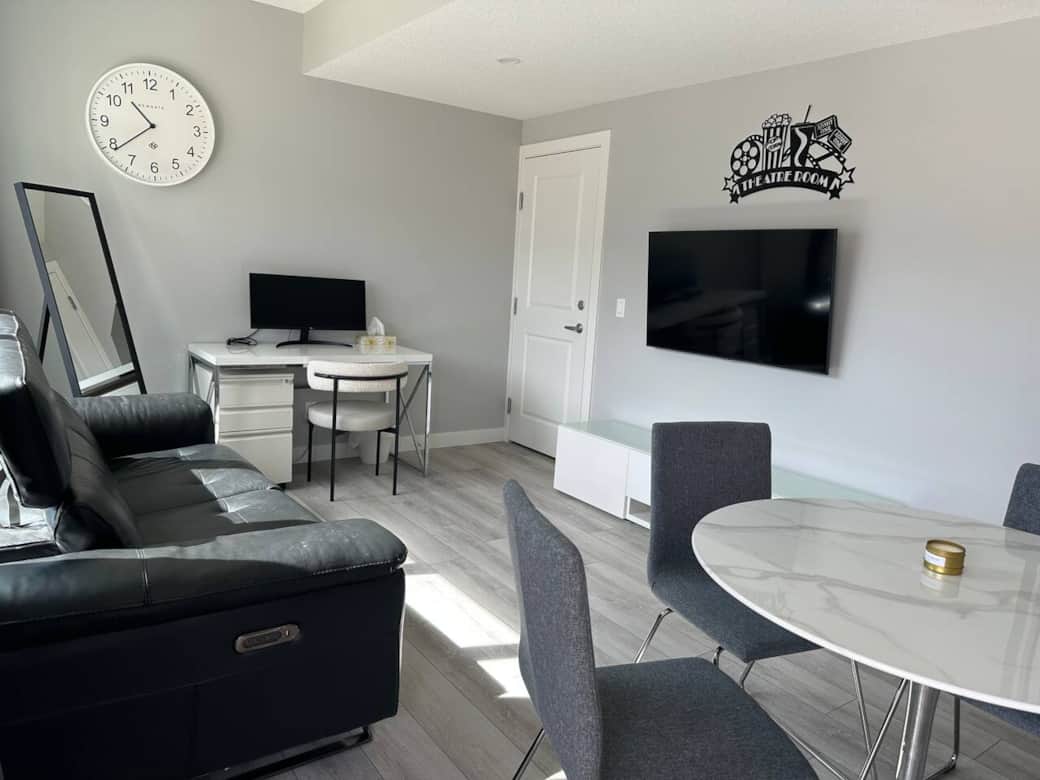 Bright and modern living space with a sleek Murphy bed, smart storage, a cozy desk setup, and comfortable seating. Perfect for relaxing, working, or enjoying a quiet night in.