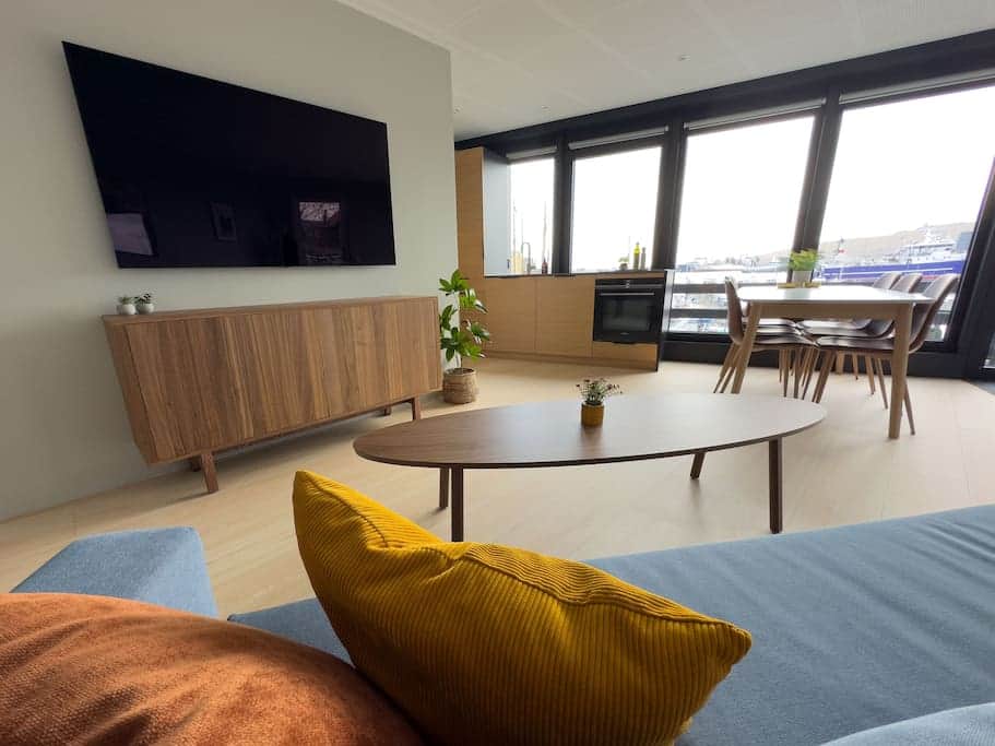 The living room is complete with a state-of-the-art 65-inch OLED TV for your entertainment needs