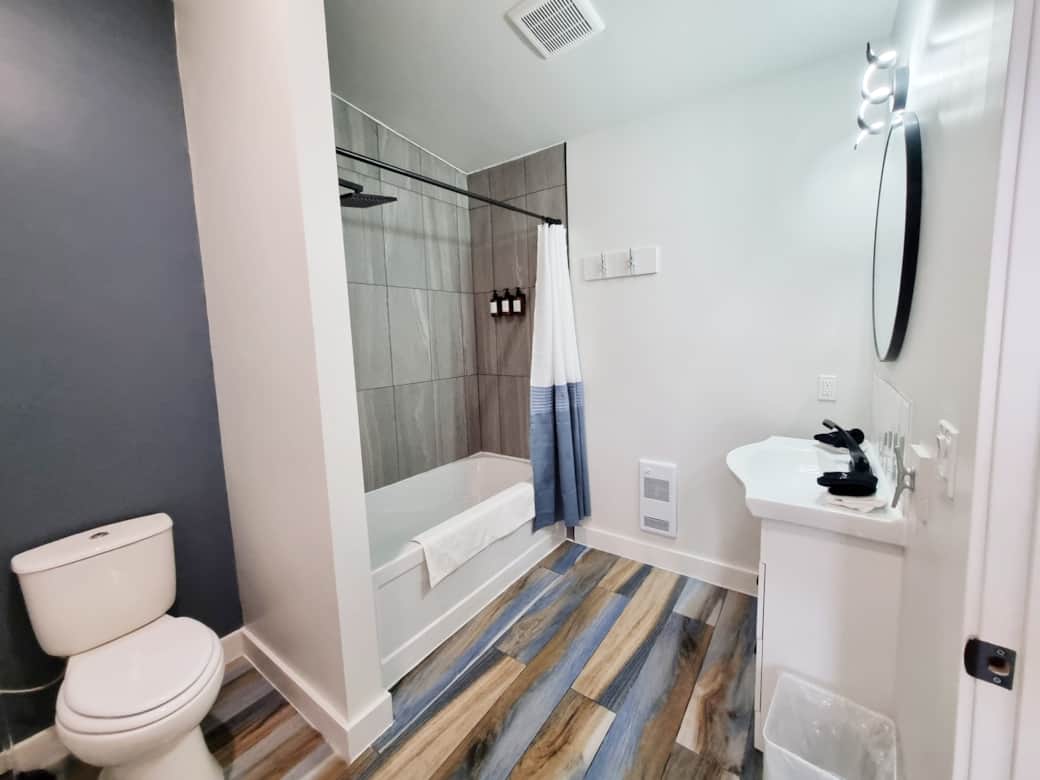 The beach-inspired bathroom features a relaxing soaker tub & a rainfall showerhead 