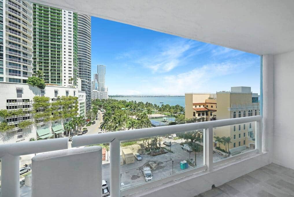 Furnished balcony with water views of Biscayne Bay and Margaret Pace Park