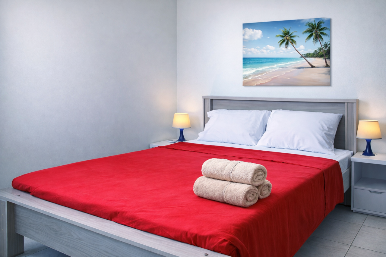 Master Bedroom: Full bed, air conditioning, linens, bath towels, reading lamps, wardrobe, & safe box