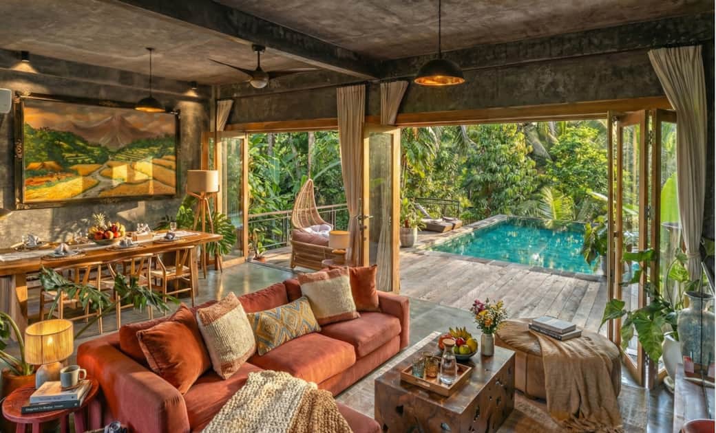 Spacious open living room with direct pool access and jungle view