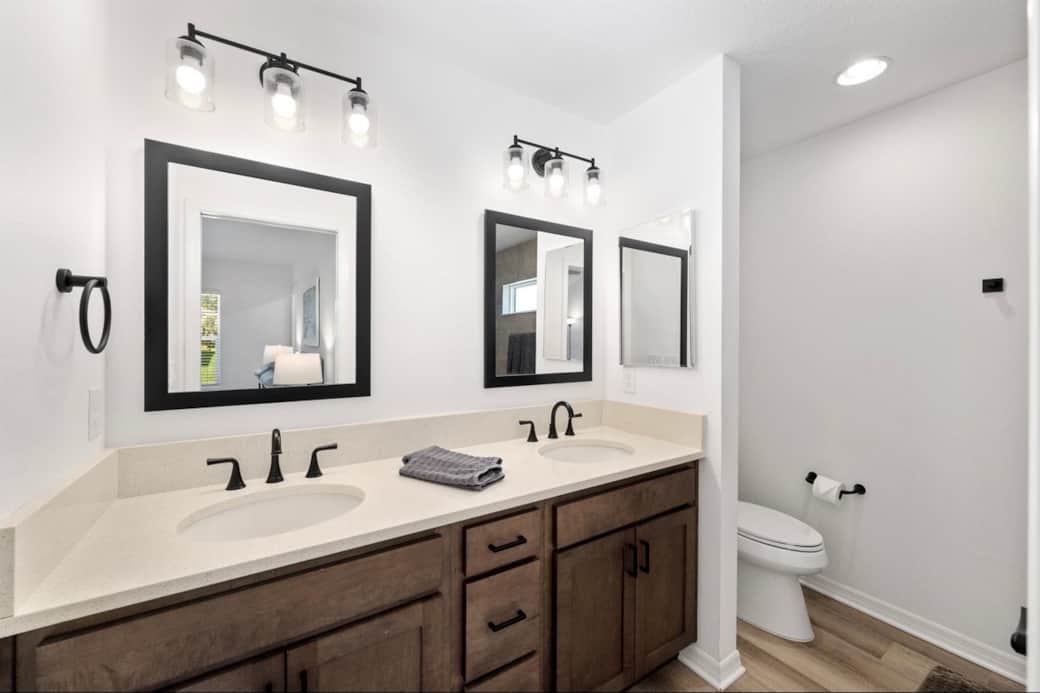 Primary ensuite bath with quartz countertops and double sinks