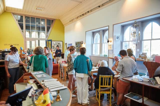 Visitors gathered inside the bright An Tobar Café in Tobermory
